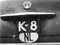 K-8, achterzijde van de Ford Custom van Van der Vliet uit Kruiningen, ca. 1952.
Bron: collectie Karel Stoel, via Europlate.
